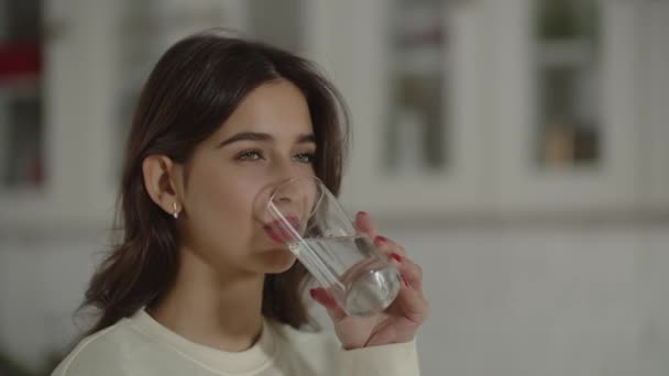 Beautiful Woman White Sweater Drinking Water Glass Brunette Girl Smiles — Stock video