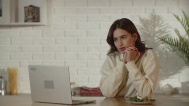 A female freelancer shakes her head in disapproval. Tired girl closes her laptop to take a break. Difficulties of remote work. High quality 4k footage