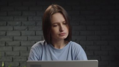 Dişi serbest çalışan kafasını laptopa çevirir ve e-postayı okuduktan sonra gülümsemeye başlar. Kumral bir kadın uzaktan bilgisayarda çalışıyor ve e-posta okuyor. Yüksek kalite 4k görüntü