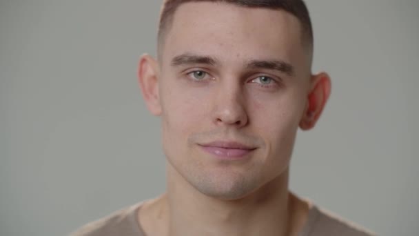 Young Man Looks Starts Smiling While Looking Straight Camera Portrait — Video Stock