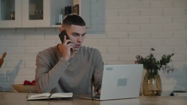 Male Freelancer Short Haircut Works Remotely Laptop Discusses Employer Phone — Video Stock