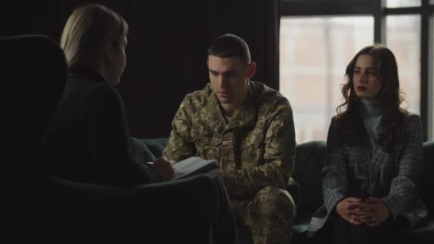 Depressed Man Military Uniform Sitting Couch His Girlfriend Tells Psychologist — стоковое видео
