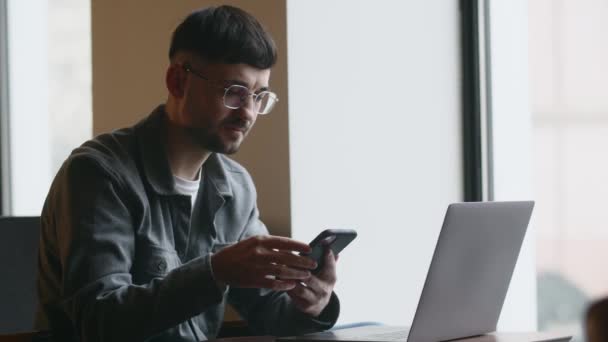 Freelancer Gafas Trabajando Con Laptop Hablando Por Teléfono Cafetería Imágenes — Vídeos de Stock