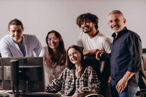 Happy team of office workers. Group of startup owners looking at camera with smile. Casual atmosphere in office. Team building . High quality photo