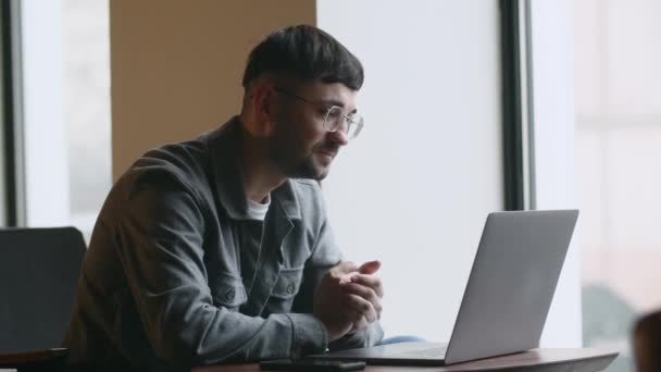 Joven Con Gafas Trabaja Remotamente Mientras Está Sentado Café Freelancer — Vídeos de Stock