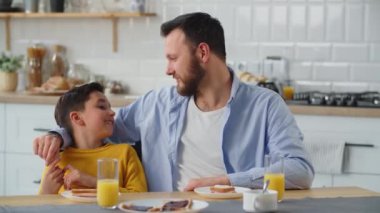 Bir adam mutfakta bir masada otururken oğluyla iletişim kurar. Sarı kazaklı çocuk okuldaki ilerlemesini babasına anlatıyor. Yüksek kalite 4k görüntü