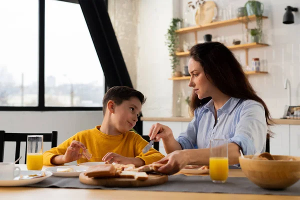 Niño Moreno Está Desayunando Con Madre Una Morena Prepara Sándwiches — Foto de Stock