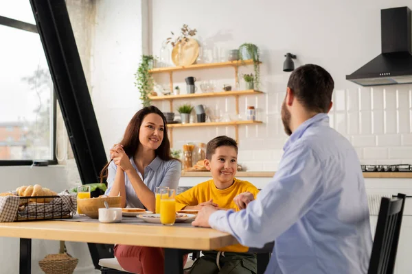 男人在家庭早餐时和家人呆在一起 一个友善的家庭坐在厨房桌旁 早餐吃着橙汁三明治 高质量的照片 — 图库照片