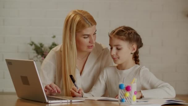 Young Mother Helps Her Daughter Homework Her Laptop Cute Mom — Stock Video
