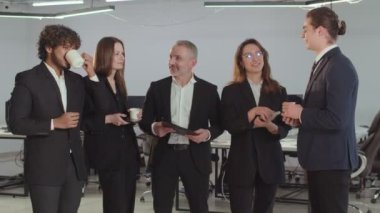 Merkezde duran ve çalışanlarıyla iletişim kuran bir finans şirketinin CEO 'su. Takım elbiseli iş adamları ofiste bir şey tartışıyorlar. Yüksek kalite 4k görüntü