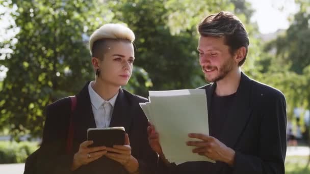 Zwei Junge Leute Stehen Vor Dem Büro Und Analysieren Papierlisten — Stockvideo