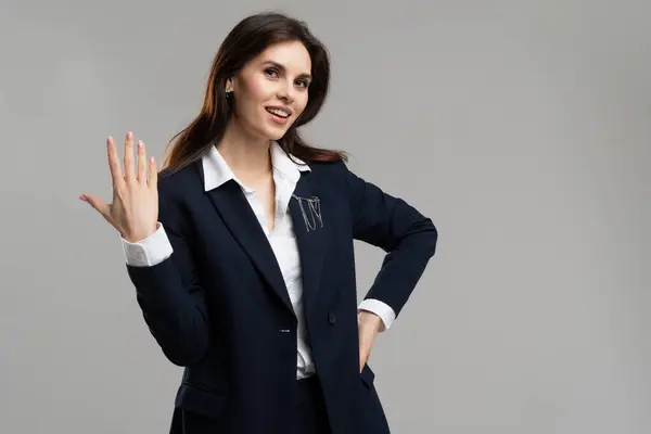 Beautiful business lady wear suit. Businesswoman showing five fingers number. Woman gesturing countdown 5 minutes left. Entrepreneur female holding palm waiting for engagement ring. High quality photo