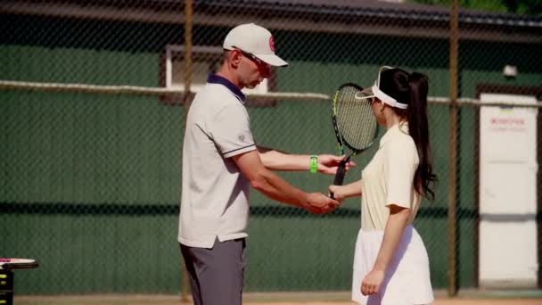 Man Tennis Coach Teaches His Ward Hold Racket Correctly Master — Stock Video