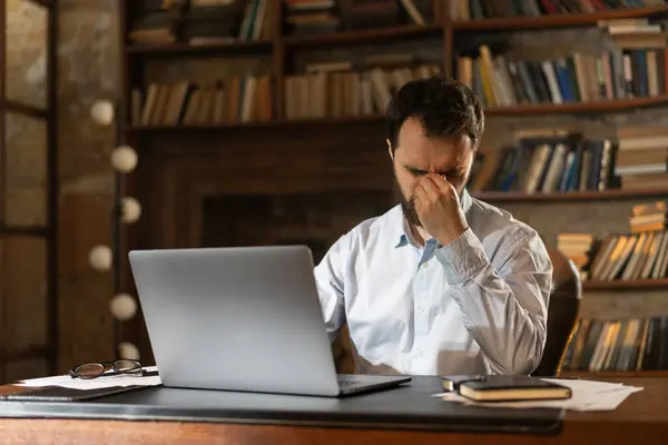 Man Squints Eyes Covers Face Hand Tiredly Sits Table Library — Stock Photo, Image