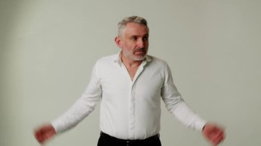 Orta yaşlı iş adamı omuz silker çünkü hiçbir fikri yoktur. Oops, benim hatam değildi. Üzgünüm ama çalışma saatlerim bitti. Maaşının nerede olduğunu bilmiyorum. Üzgünüm patron. Yüksek kalite 4k görüntü