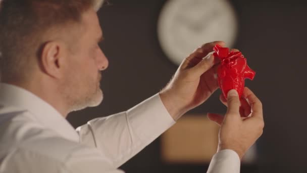 Man Graphic Designer Sideways Holds Hands Views Plastic Printed Model — Stock Video