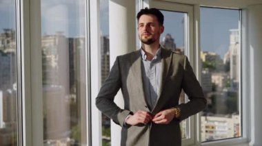 Man sitting on the roof of a big building and look at the city. Concept of big money, success, when dreams comes true. High quality 4k footage