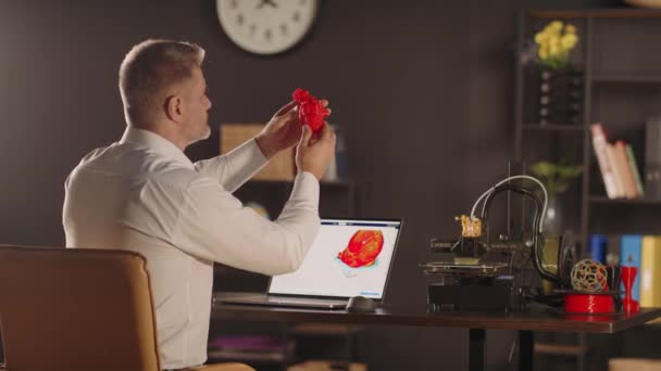 Man Graphic Designer Sideways Holds Views Plastic Printed Model Human — Stock Video