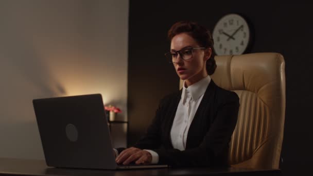 オフィスの快適な革の椅子に座ってノートを使用する若い女性の肯定的なボス 専門の女性シニアレベルのプログラマーです コンピュータを使用するビジネス分析女性 書類もない — ストック動画
