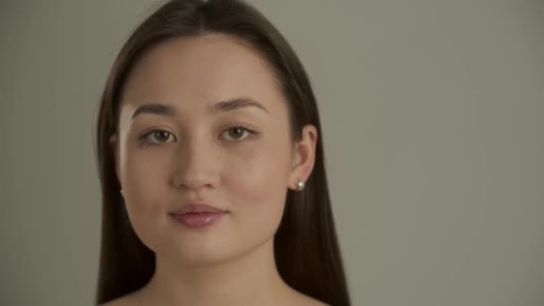 Mooie Aziatische Vrouw Poseert Tegen Een Grijze Muur Een Jonge — Stockvideo