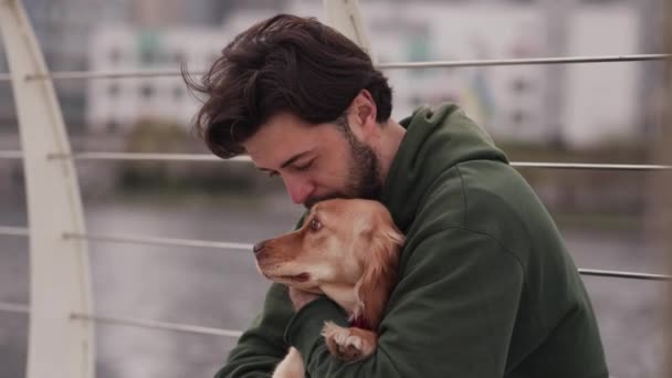 Een Man Zit Met Zijn Hond Een Brug Met Een — Stockvideo