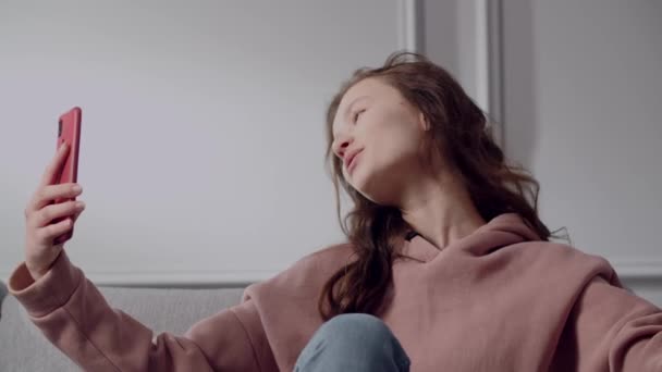 Positive Coquettish Mischievous Girl Teenager Sits Room Sofa Cozy Home — стокове відео