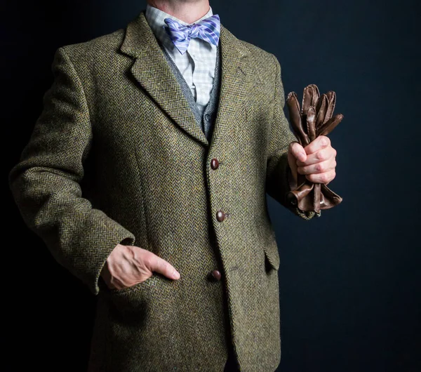 Portrait of Man in Tweed Suit Holding Brown Leather Gloves. Vintage Style and Retro Fashion of Classic English Gentleman.