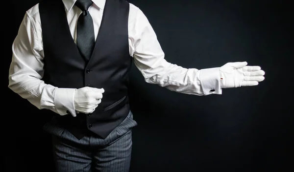 Portrait of Butler in White Gloves Standing With Welcoming Gesture. Concept of Service Industry and Professional Hospitality.