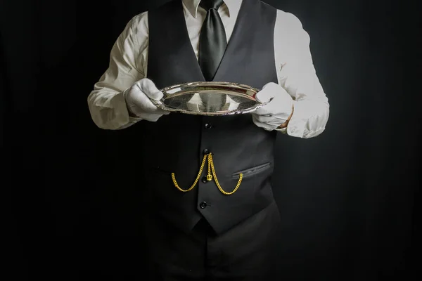 Butler or Waiter in White Gloves Holding a Silver Tray. Concept of Service Industry and Professional Hospitality