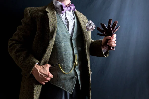Portrait of Gentleman in Tweed Suit Holding Leather Gloves. Concept of Classic and Eccentric English Gentleman. Vintage Style and Retro Fashion.