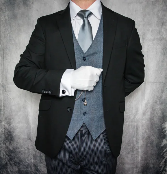 Portrait of Butler or Hotel Concierge in Dark Suit and White Gloves Eager to Be of Service. Concept of Elegant Hospitality and Professional Courtesy.