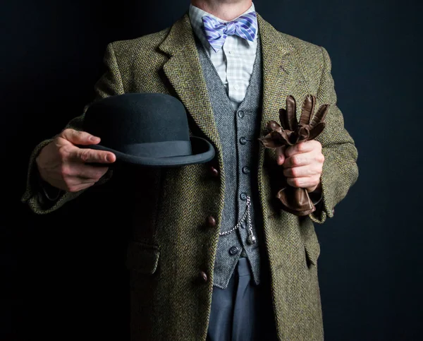 Portrait of Elegant English Gentleman in Tweed Suit Holding Bowler Hat. Vintage Style and Retro Fashion of British Gentleman.