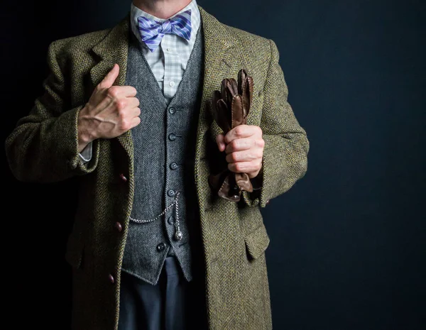 Portrait of Man in Tweed Suit Holding Brown Leather Gloves. Vintage Style and Retro Fashion of Classic English Gentleman.