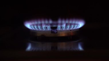 Gas burner burns blue flame, close-up. Blue Flame. Gas stove being turned on by a lit burner. Natural gas concept.