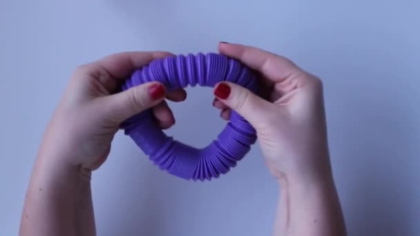 Female Hands Playing Stress Blue Pop Tube Toy White Background — Stock video