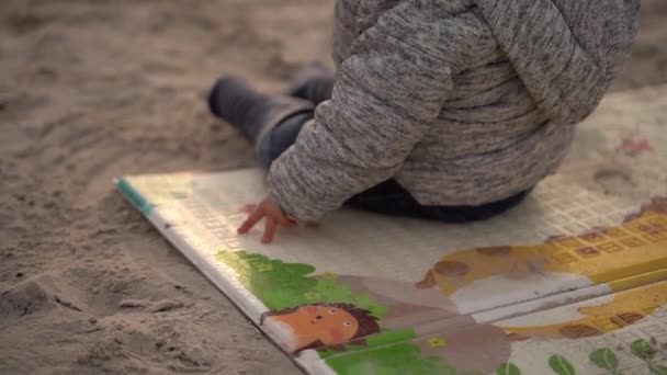 Child Sits Mat Sand Bends Mat Carries His Hand Sand — Vídeos de Stock