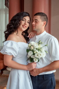 Happy,beautiful bride and groom in interior of hotel in wedding day. High quality photo