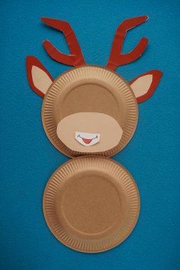 Christmas New Year Santa's deer handmade. Step by step photo instruction. DIY concept. Step 7-13. Cut out a white oval, draw a funny mouth on it and glue it to the face of a deer. Top view, Flat lay