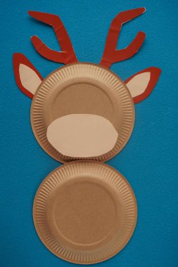 Christmas New Year Santa's deer handmade. Step by step photo instruction. DIY concept. Step 6-13. Cut a flesh-colored oval and glue the face of a deer. Top view, Flat lay