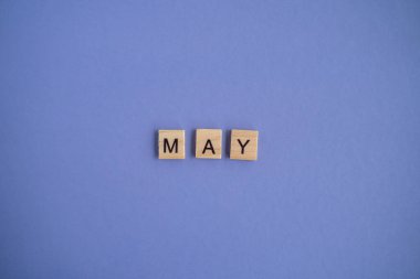 The fifth month of the year May - from individual letters on wooden blocks in natural color, in high resolution. Very Peri Color of the year background, copy space. Flat lay, step by step, step 5
