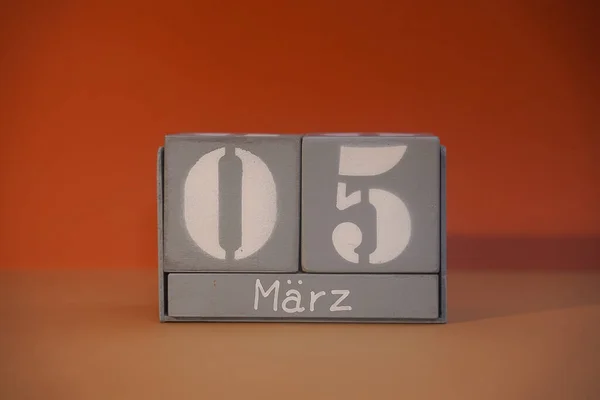 5 Marz on wooden grey cubes. Calendar cube date 05 March. Concept of date. Copy space for text or event. Educational cubes. Wood blocks in box with date, day and month. Selective focus