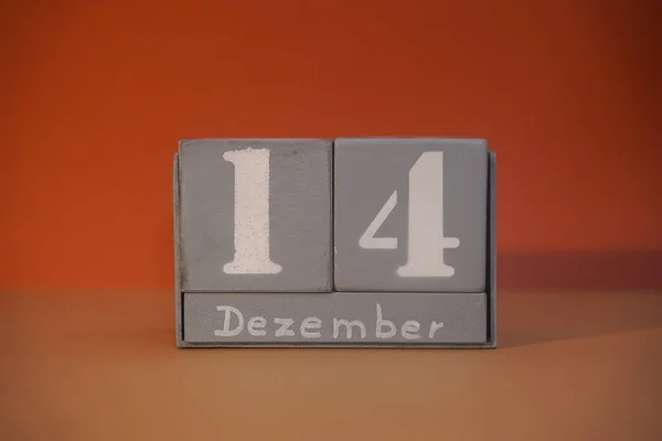 14 Dezember on wooden grey cubes. Calendar cube date 14 December. Concept of date. Copy space for text or event. Educational cubes. Wood blocks in box with german date, day and month. Selective focus