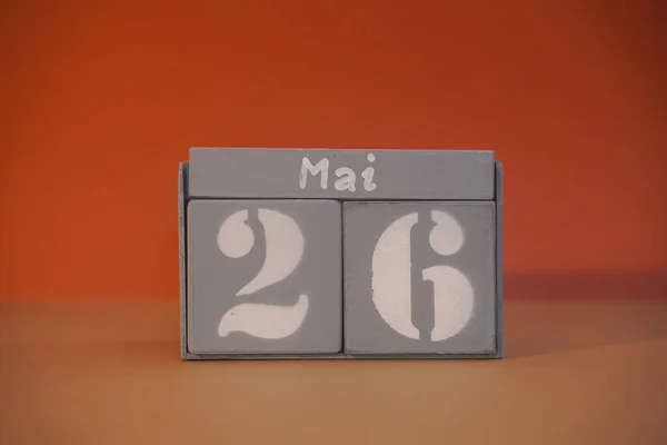 26 Mai on wooden grey cubes. Calendar cube date 26 May. Concept of date. Copy space for text or event. Educational cubes. Wood blocks in box with german date, day and month. Selective focus