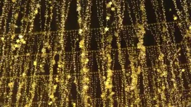 New Years garlands in the night city against the sky. Night alley with bright lanterns and stars. Night City.