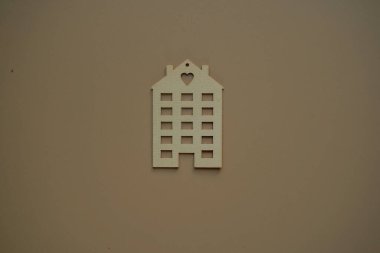 Flat wooden private house on beige background view from above. Quarantine COVID 19 - stay at home be safe. Blurred background