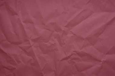 Abstract red paper wrinkled or crumpled texture background close-up top view, red texture, rumpled red paper. Abstract paper background and wallpaper. Material for gift wrapping. Craft material