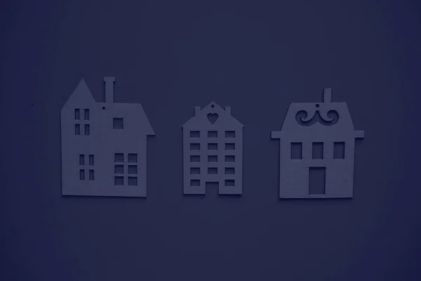 Design of houses, creative design and design bureau. Flat wooden houses on blue background view from above. Concept of a creative approach to the design of houses and housing.
