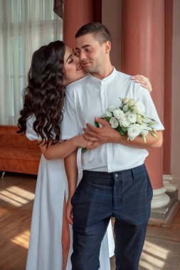 Happy,beautiful bride and groom in interior of hotel in wedding day. High quality photo
