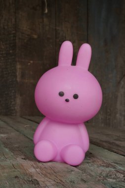 Close up Easter bunny rabbit statuette. Easter egg hunt in the garden. Selective focus, copy space.