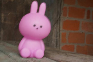 Close up Easter bunny rabbit statuette. Easter egg hunt in the garden. Selective focus, copy space.